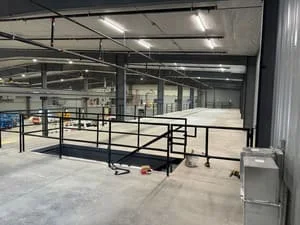 Welded steel livestock handling gates and panels with structural framework in industrial facility