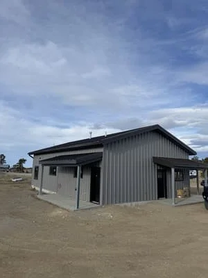 Steel-framed agricultural building with corrugated metal cladding and gable roof