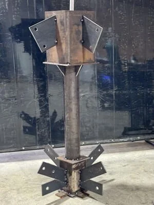 Steel post with welded brackets and flanges, wooden core, structural assembly