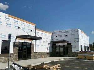 Steel frame commercial building with metal sheathing and structural steel columns during construction