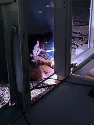 Welded steel frame enclosure with hinged door and structural steel construction