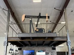 Steel mezzanine platform with overhead jib crane and safety railings in industrial facility