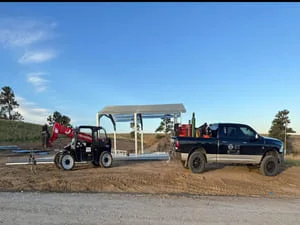 Custom steel livestock trailer with welded frame and reinforced panels on dirt lot