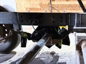 Steel pintle hook hitch assembly with welded brackets on trailer frame