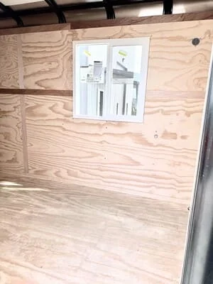 Steel frame enclosure with plywood panels and mounted electrical panel diagram
