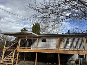 Steel-framed residential deck with welded posts, beams, and wood decking