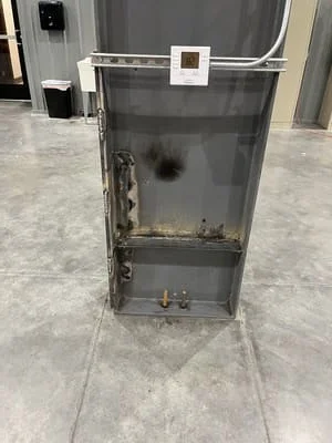 Welded steel enclosure with hinged door, internal bracing, and mounting hardware